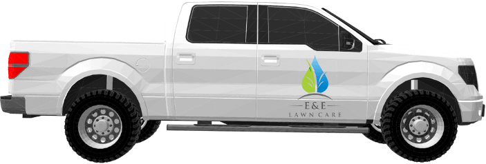 An E&E Lawn Care work truck as seen from the side. It is branded with their logo.