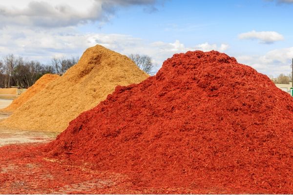  Two piles of red and brown mulch